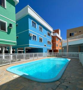 a swimming pool in front of a building at Condomínio San Victor in Bombinhas