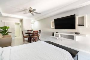 a bedroom with a bed and a flat screen tv at City Edge La Vie in Kingston