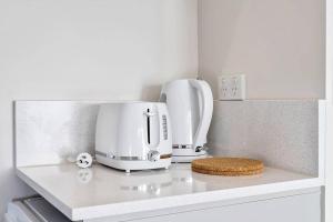 a kitchen counter with a coffee maker and a toaster at Cozy Studio located in Crows Nest in Sydney