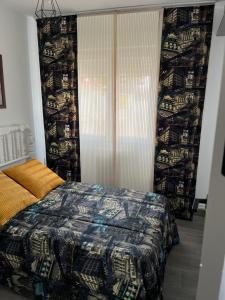 a bedroom with a bed and a large window at Paz Jardín-Madrigueras in Madrigueras
