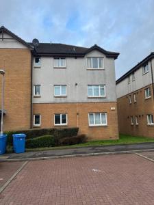 a large brick building with windows on a street at 5 minutes to Glasgow airport in Paisley