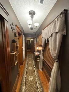 a hallway of a home with a curtain on a window at The Queen's Gambit ( A Luxury 2nd Floor Apt in Downtown Staunton) in Staunton