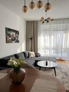 a living room with a couch and a table at Sundeck City Centre Apartment in Bratislava