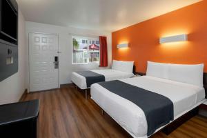 a hotel room with two beds and a window at Motel 6-Carpinteria, CA - Santa Barbara - South in Carpinteria