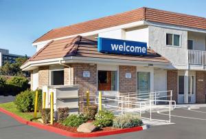 a welcome sign on the front of a building at Motel 6-San Jose, CA - Airport in San Jose