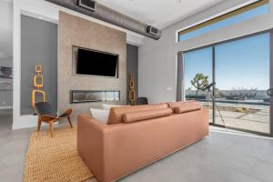 - un salon avec un canapé brun et une télévision dans l'établissement Mountain View Paradise -POOL & SPA, à Yucca Valley
