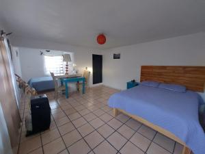 a bedroom with a bed and a table and a desk at Casa Nopal Tu casa vacacional tipo hotel in Creel