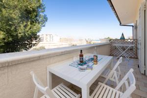 a white table and chairs on a balcony at Casa Torre di Specchio 2 con Piscina in Bari
