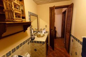 a bathroom with a sink and a mirror at Casa Laurel Oaxaca in Oaxaca City