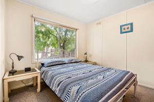 a bedroom with a bed and a window at Ventnor Getaway in Ventnor