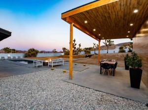 a pavilion with a table and a view of the desert at Luxury Desert Retreat w Pool & Jacuzzi in Joshua Tree