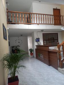 a room with a staircase and a lobby with a plant at villa de las palmas in Palmira