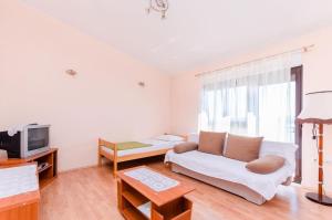 a living room with a couch and a tv at Apartments Nenad in Dramalj