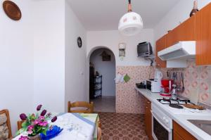 a kitchen with a table and a counter top at Apartment Anica in Kampor