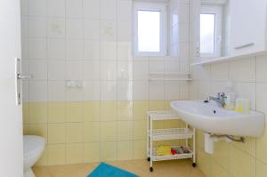 a bathroom with a sink and a toilet at Apartments Darko by the sea in Supetarska Draga