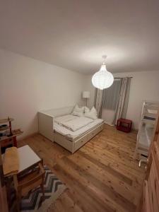 a living room with a bed and a chandelier at Broockhof Ferienwohnung unterm Sternenhimmel in Mecklenburg in Reimershagen