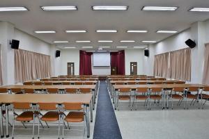 an empty lecture hall with tables and chairs at Hyundai Soo Resort Hoengseong in Pyeongchang