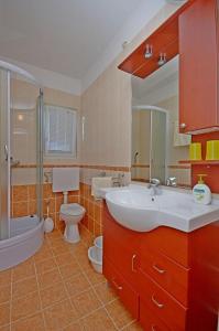 a bathroom with a sink and a toilet and a shower at Apartments Vesna in Lastovo