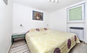 a bedroom with a bed and a table and a window at Apartment Sanja in Martina