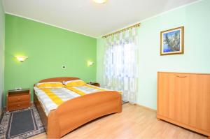 a bedroom with a bed with green walls at Apartments Marija in Umag