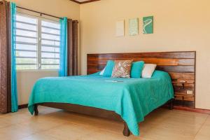 a bedroom with a bed with a wooden headboard at The Junior Suite's "Palm Studio Apartment" in South Hill Village