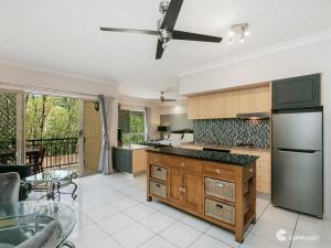 a large kitchen with a table and a dining room at The Lakes Resort Cairns in Cairns