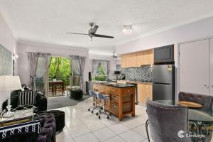 a kitchen with a table and chairs in a room at The Lakes Resort Cairns in Cairns