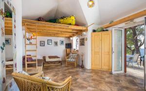 a room with a loft bed and a living room at House Vesna Kupinova in Milna