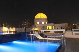a building with a dome on top of it at night at The Pllazio Hotel in Gurgaon