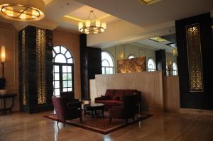 
a living room filled with furniture and a large window at The Pllazio Hotel in Gurgaon
