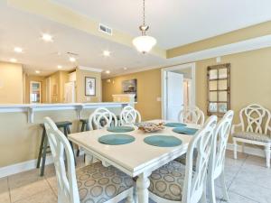 a kitchen and dining room with a table and chairs at Gull Reef 635 in Tybee Island