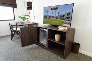 a entertainment center with a flat screen tv on top at Serene Vegas Boutique Hotel Las Vegas in Las Vegas