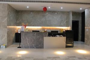 a lobby with a reception desk and a red balloon at CHECK inn Taichung Qinghai in Taichung