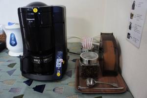 a coffeemaker sitting on a counter next to a coffee maker at EK House Hakone Shushinso 箱根修身荘 in Onsensō