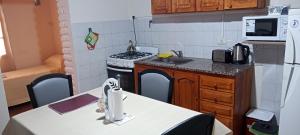 a small kitchen with a stove and a sink at Departamento Del Sol (Esquel-Chubut) in Esquel