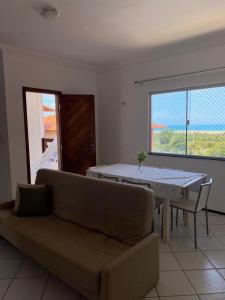 a living room with a couch and a table at Porto das Dunas in Aquiraz