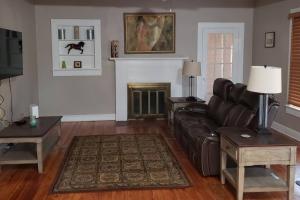 a living room with a couch and a fireplace at Southside Jax great home RV parking in Jacksonville