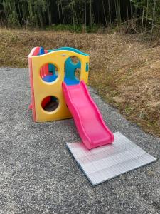 a childs play set with a slide on the ground at FRIENDS in Futae