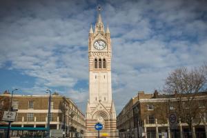 a tall clock tower with a clock on it at Lovely 1 Bedroom Flat In Gravesend in Kent