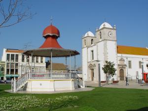 un edificio con una torre dell'orologio accanto a un edificio con una torre dell'orologio di Hotel O Catraio a Montijo