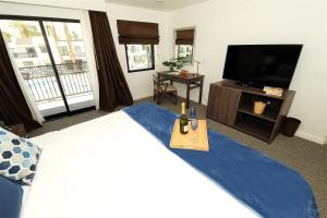 a bedroom with a large bed and a flat screen tv at Serene Vegas Boutique Hotel Las Vegas in Las Vegas