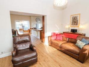 a living room with a couch and two chairs at Lightkeeper House in Amble