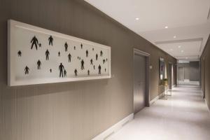 a painting of people on a wall in a hallway at Le Meridien Visconti Rome in Rome
