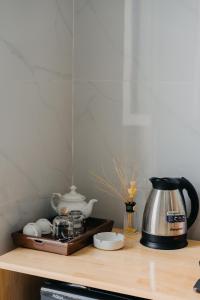 a kitchen counter with a coffee maker and a tea kettle at Home Sweet Home in Tây Ninh