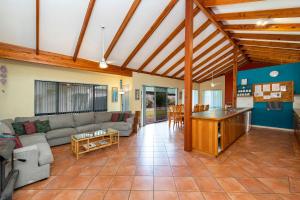 a living room with a couch and a table at Holiday on the Terrace in Dunsborough