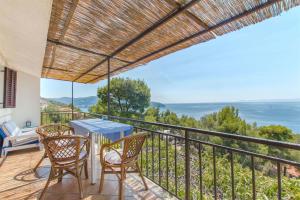 a balcony with a table and chairs and the ocean at Apartments Ana in Blato
