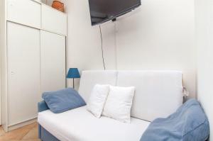 un sofá blanco con 2 almohadas en una habitación en Apartments Ana, en Brna