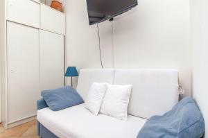 a white couch with two pillows on it in a room at Apartments Ana in Blato