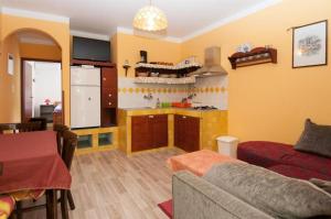a living room with a couch and a kitchen at Apartments Nevenka in Mali Lošinj