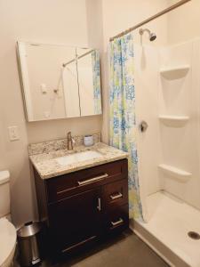 a bathroom with a sink and a shower at Modern studio, Heart of Riverside Sq. mins shops. in East Providence